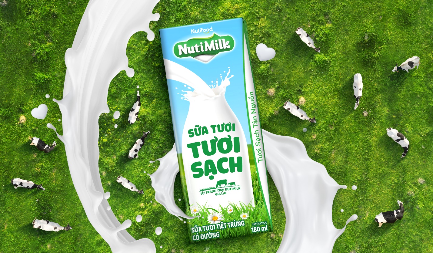 A carton of milk on a green surface  Description automatically generated