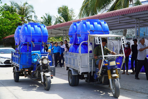 Người dân Sóc Trăng nhận bồn chứa nước ngọt do các doanh nghiệp tặng Ảnh: LÊ HOÀNG