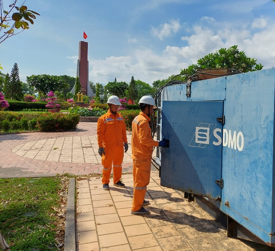 Men in orange jumpsuits standing next to a blue box  Description automatically generated