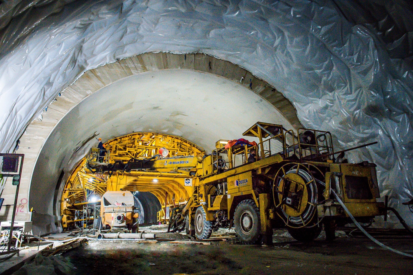 A large yellow vehicle inside a tunnel  Description automatically generated