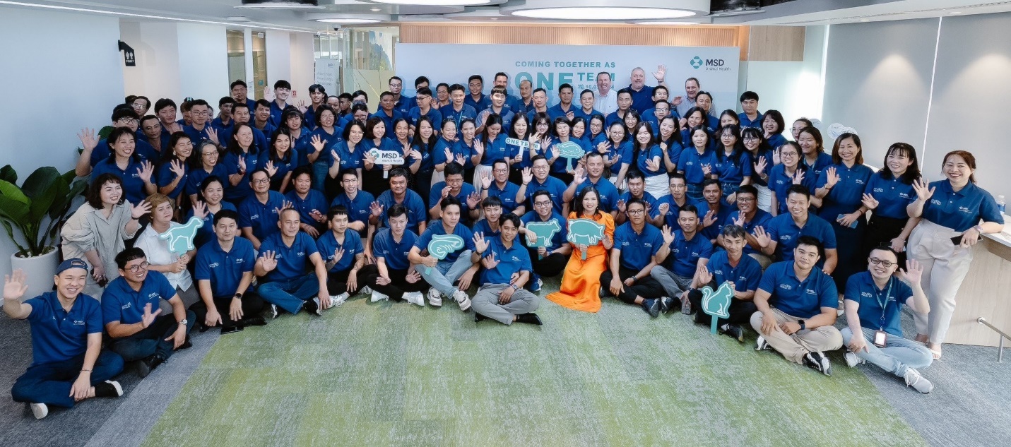 A group of people in blue shirts  Description automatically generated