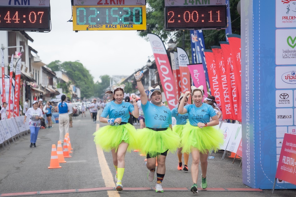 A group of women running in tutu skirts  Description automatically generated