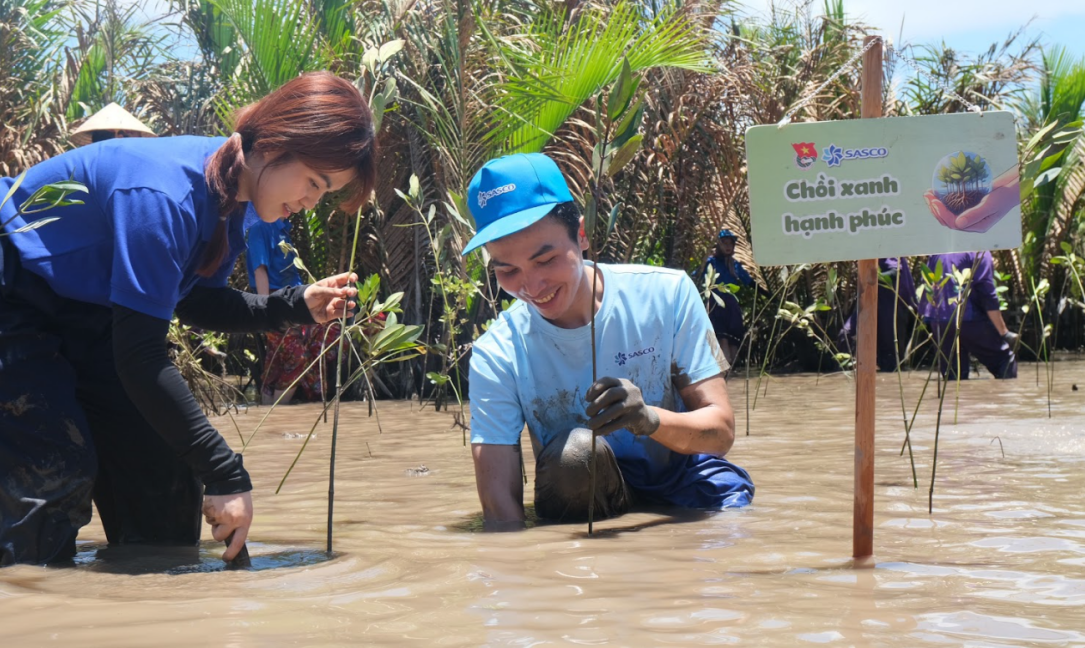 A group of people in a muddy area  Description automatically generated