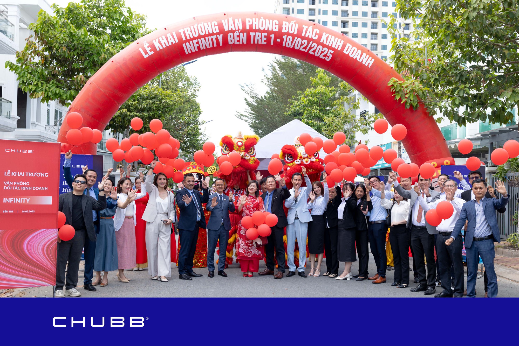 A group of people standing under a red arch  AI-generated content may be incorrect.