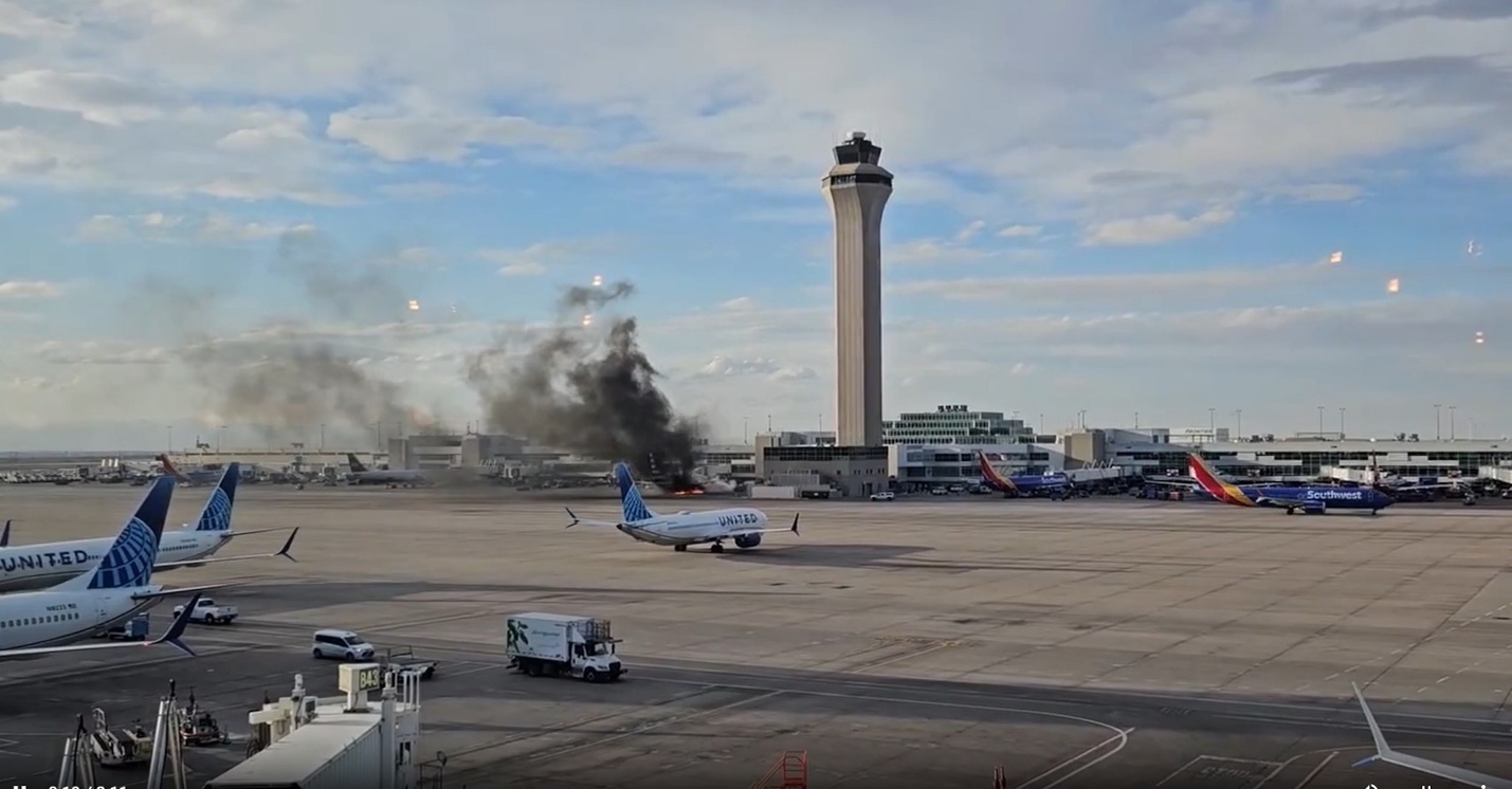 PHOTO: Smoke and flames surround an American Airlines plane at Denver International Airport on March 13, 2025.