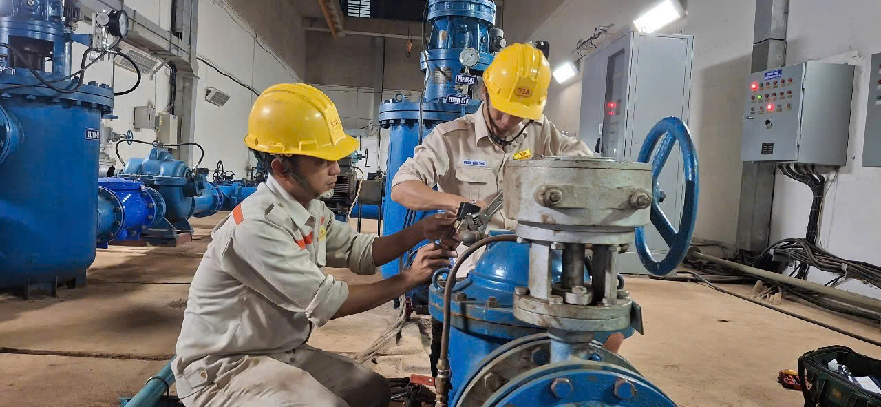 Men wearing yellow hard hats working on a machine  AI-generated content may be incorrect.