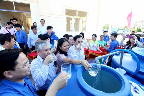 Lãnh đạo UBND tỉnh Bến Tre, Trung ương Đoàn TNCS Hồ Chí Minh cùng người dân uống thử nước đã qua xử lý của máy lọc Ảnh: Khánh Lê