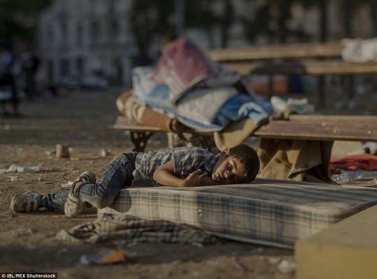 Abdullah, 5 tuổi, ngủ trên một tấm nệm bẩn thỉu bên ngoài nhà ga trung tâm ở Belgrade - Serbia. Cậu bé mắc bệnh liên quan đến đường máu và không có tiền đến bệnh viện. Mẹ Abdullah cho biết con trai bà vẫn còn bị sốc sau khi chứng kiến cảnh em gái bị giết hại ở TP Daraa - Syria. Ảnh: IBL