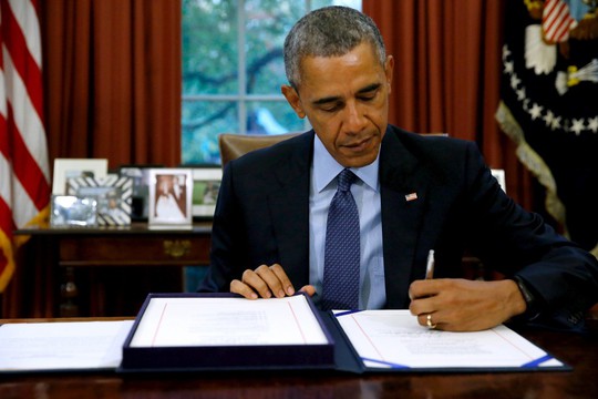 Tổng thống Mỹ Barack Obama ký dự luật ngân sách tại Phòng Bầu dục hôm 2-11. Ảnh: Reuters