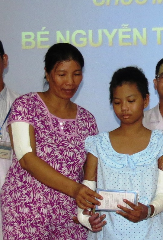 
Bà Duy đưa bé Linh xem quyển sổ tiết kiệm mà đơn vị trợ giúp xã hội của Bệnh viện Nhi Đồng 1 đã gom góp lại từ các nhà hảo tâm và trao lại gia đình trong ngày xuất viện
