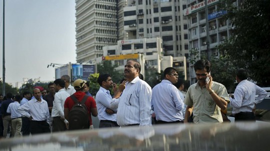 
Nhân viên văn phòng ở New Delhi - Ấn Độ chạy ra ngoài đường khi động đất xảy ra. Ảnh: REUTERS
