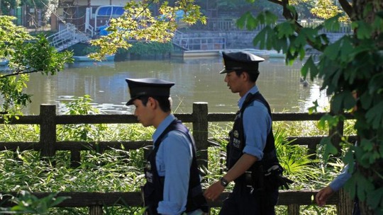 Cảnh sát đi cạnh ao nước tại công viên Himonya để tìm kiếm thêm các bộ phận cơ thể còn lại. Ảnh: AP