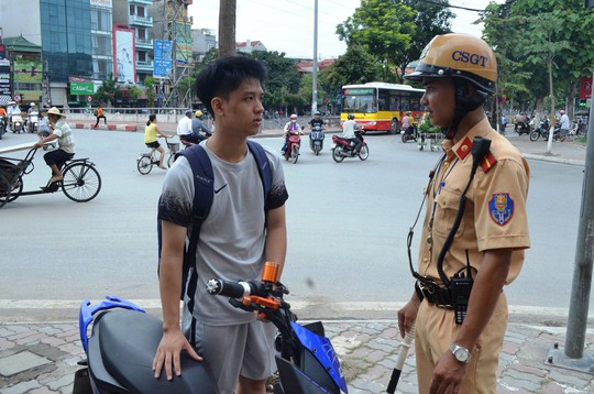 Một trường hợp đi xe máy điện không đội mũ bảo hiểm bị CSGT Hà Nội nhắc nhở Ảnh: NGUYỄN HƯỞNG