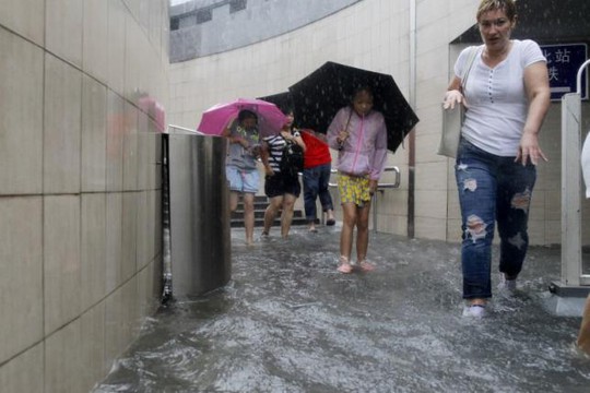 Người dân thủ đô Trung Quốc đang hứng chịu những cơn mưa nặng hạt kéo dài. Ảnh: REUTERS