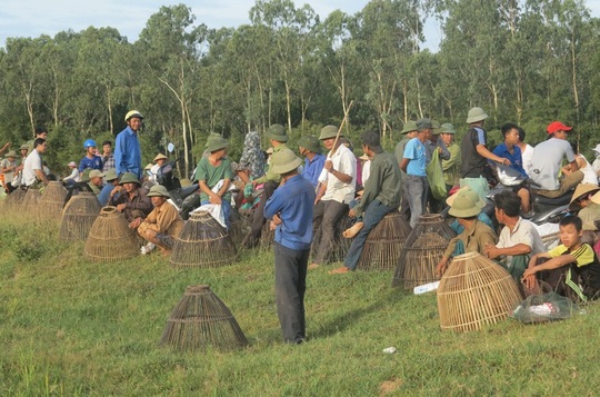 
Người dân chuẩn bị các dụng cụ truyền thống đứng trên bờ chờ hiệu lệnh xuống đầm bắt cá

 
