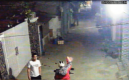 Nguyễn Hoàng Minh (trái) trước khi tấn công ông Lưu Thanh Sơn để cướp tài sản hôm 23-2. (Ảnh trích từ camera an ninh)