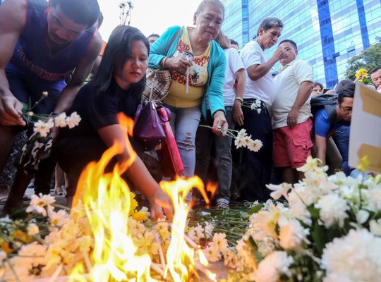 
Người dân đặt hoa tưởng niệm các nạn nhân vụ nổ ở chợ đêm 2-9. Ảnh: AP
