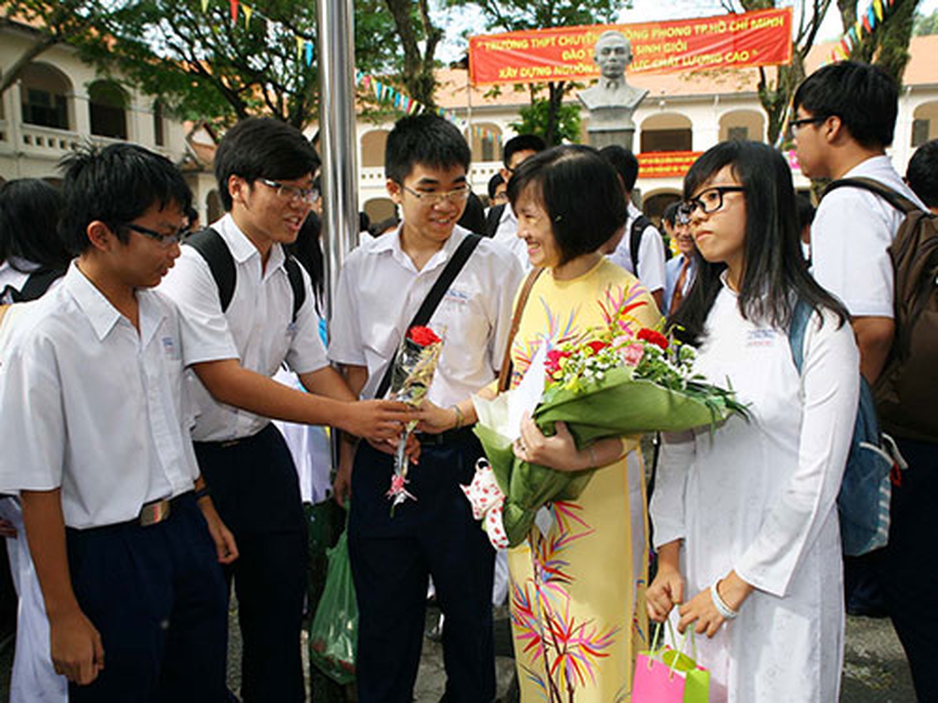 Học sinh Trường THPT L&ecirc; Hồng Phong (TP HCM) tặng hoa cho gi&aacute;o vi&ecirc;n nh&acirc;n ng&agrave;y 20-11.  Ảnh: HO&Agrave;NG TRIỀU
