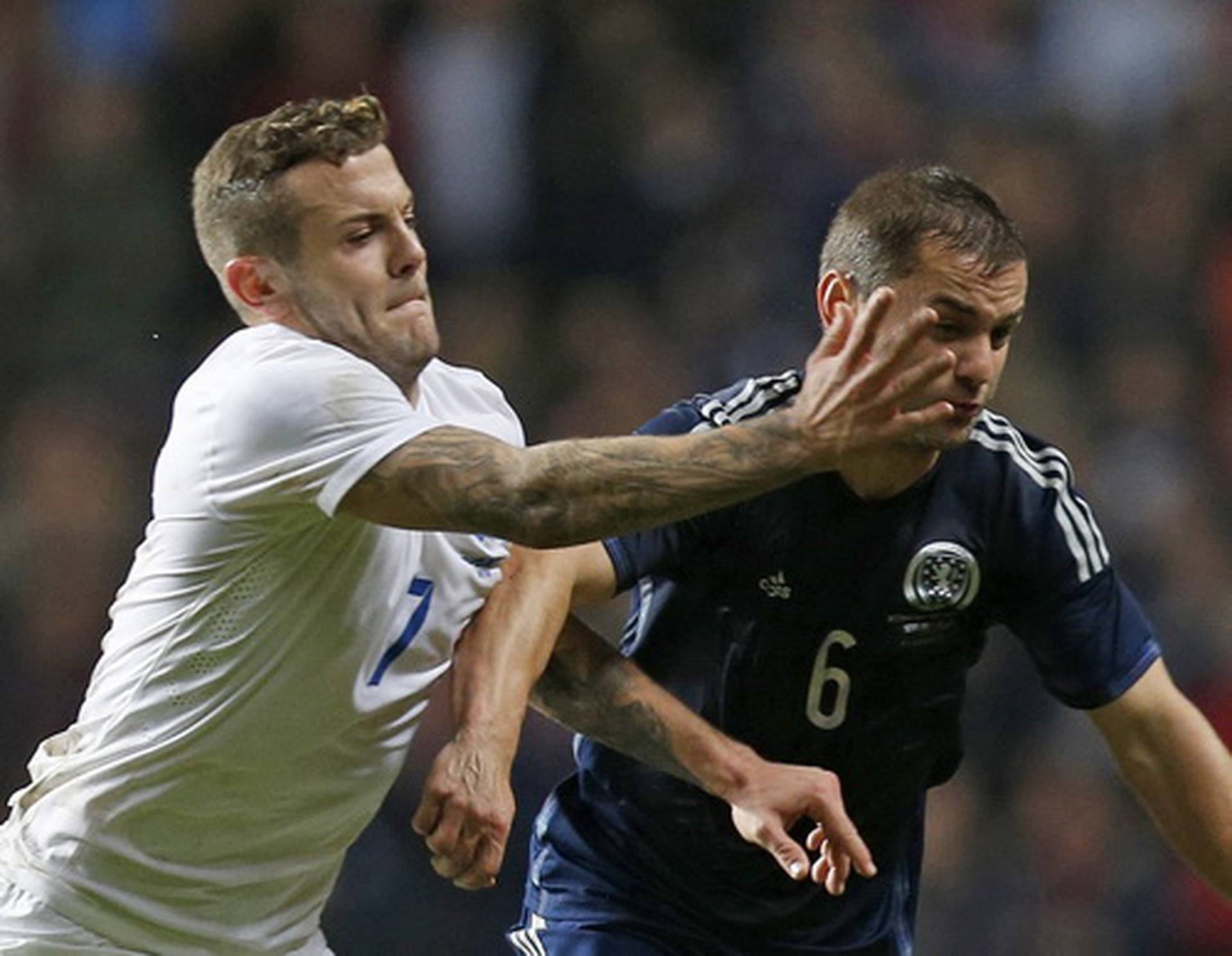 Jack Wilshere (7) tranh b&oacute;ng quyết liệt với Shaun Maloney