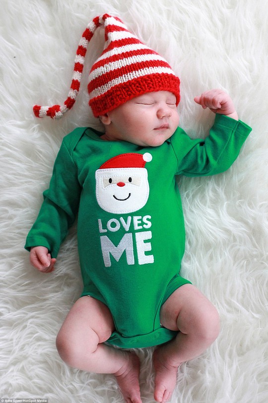 Jackson, under two weeks old, wears a full Christmas outfit as he naps