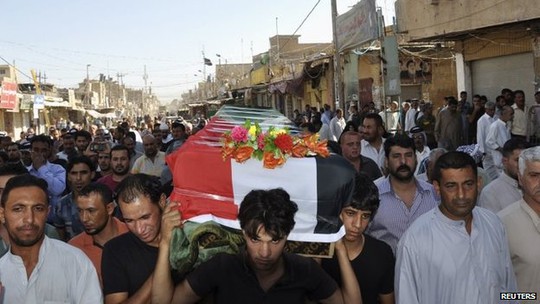 Mourners carry the coffin of a victim killed by a suicide bomb attack in Mahmoudiyah