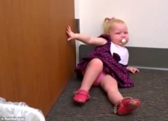 The little girl ends up in a heap on the floor after refusing to have anything to do with her newborn sister