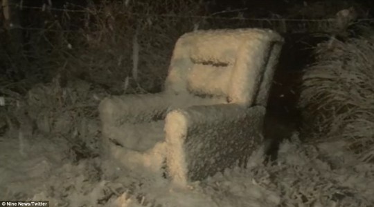 A lone arm chair is covered in thick snow after a blanket of white powder falls across Stanthorpe
