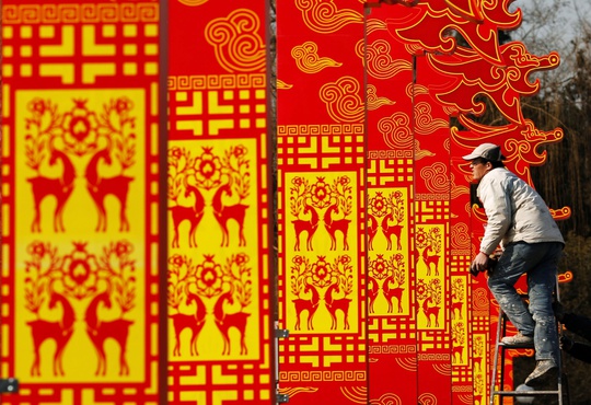 A man installs decorations for the upcoming Chinese Lunar New Year celebrations at Taoranting park in Beijing February 9, 2015. Photo by Kim Kyung-Hoon/REUTERS.