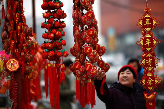 A woman looks at traditional decorations celebrating for the upcoming Chinese Lunar New Year at a market in Beijing February 6, 2015. Photo by Kim Kyung-Hoon/REUTERS.