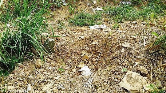 Police rushed to the Feng Long Ridge area, where the baby had been buried just 5cm underground hidden in a cardboard box. Doctors believe rainwater provided enough moisture to keep him alive