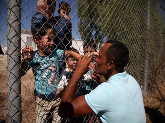Cảm động nụ hôn qua hàng rào của ông bố tị nạn người Syria - Ảnh 2.