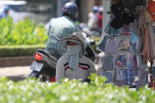 
Bà Thanh (45 tuổi), bán khẩu trang, bao tay tại ngã tư đường Nguyễn Thị Minh Khai -Cách Mạng Tháng 8, cho biết: Hôm nay, TP HCM nóng quá, dù đã tìm được một chỗ có bóng mát để ngồi nhưng tui vẫn thấy nóng và uể oải

