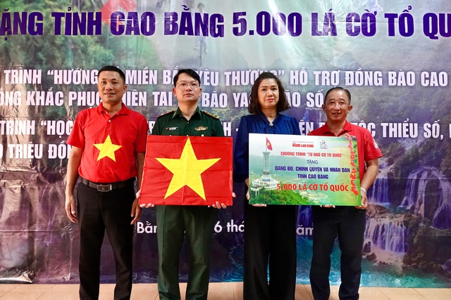 Ông Bùi Thanh Liêm - Phó Bí thư Đảng ủy, Phó Tổng Biên tập Báo Người Lao Động (bìa phải) và đại diện đơn vị đồng hành trao cờ Tổ quốc, bảng tượng trưng cho thượng tá Lương Tuấn Long - Phó Chính ủy Bộ đội Biên phòng tỉnh và bà Nguyễn Hồng Vân, Phó Chủ tịch Ủy ban MTTQ tỉnh Cao Bằng