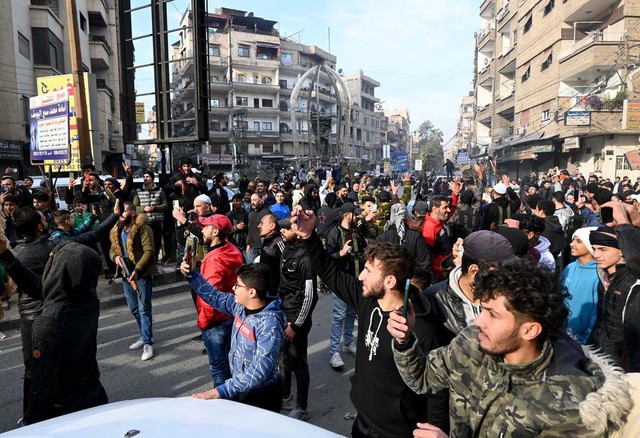 Locals rally in a street in Damascus, Syria, Dec. 8, 2024. (Photo by Ammar Safarjalani/Xinhua)