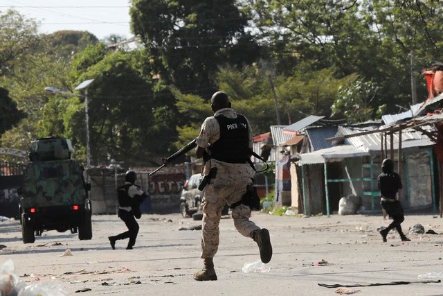 Cảnh sát giao tranh với một băng đảng ở thủ đô Port-au-Prince - Haiti ngày 1-3 Ảnh: REUTERS