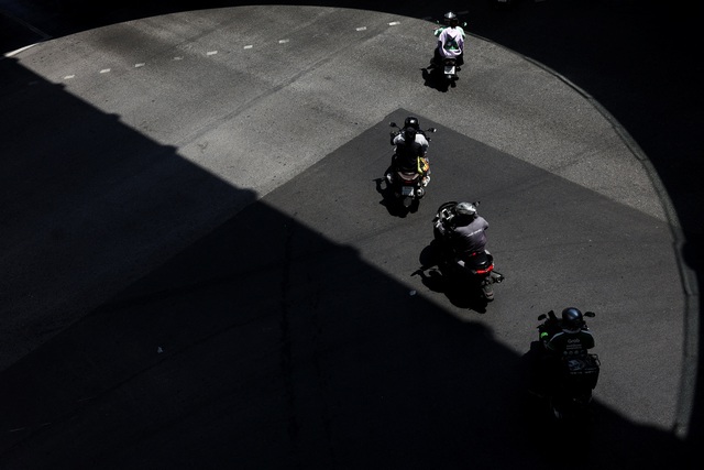 Xe máy chạy ngoài đường ở thủ đô Bangkok - Thái Lan hôm 31-3 khi nhiệt độ lên tới 39 độ C Ảnh: REUTERS