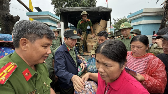 Giám đốc Công an tỉnh Đắk Lắk phát nhu yếu phẩm cho người dân vùng lũ - Ảnh 4.