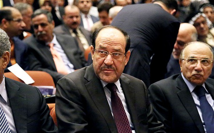 Iraqi Prime Minister Nouri al-Maliki (C) attends the first session of parliament on Tuesday in Baghdad, Iraq