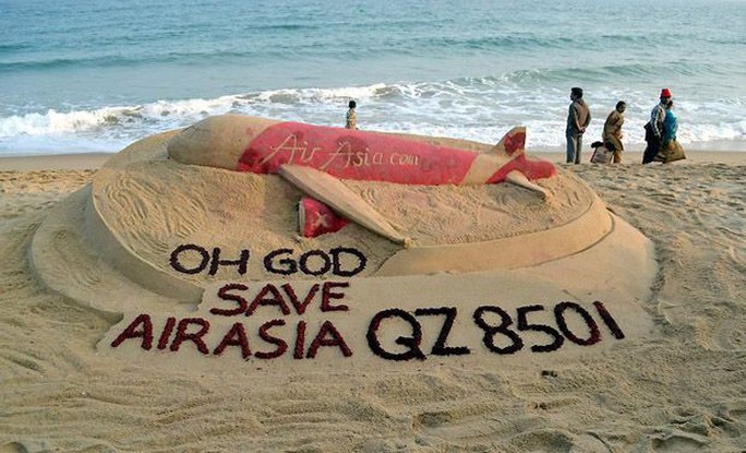 Sand artist Sudarshan Pattnaik makes a sand art to pray for Air Asia Indonesia airliner which went missing on its way to Singapore with 162 people on board at Gopalpur sea beach  (Photo: PTI)