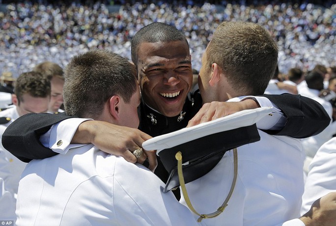 Happiness: The men embrace after they were given their diplomas by the vice president on Friday