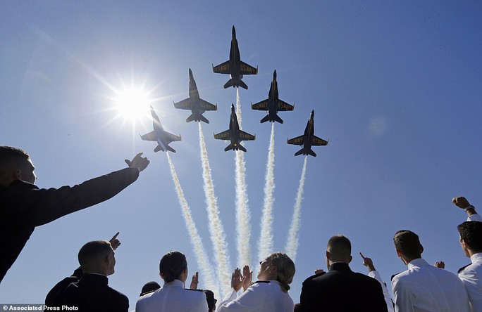 Celebration: The Blue Angels flight demonstration team flies over graduating members of the academy