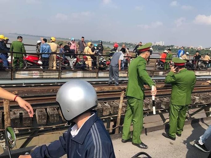 Thanh niên buồn chuyện gia đình ôm con nhỏ ngồi vắt vẻo trên thanh giằng cầu Long Biên - Ảnh 2. Thanh niên buồn chuyện gia đình ôm con nhỏ ngồi vắt vẻo trên thanh giằng cầu Long Biên - Ảnh 2.