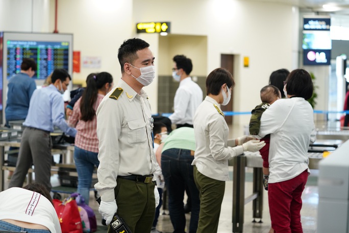 Dòng người đeo khẩu trang tại sân bay Nội Bài - Ảnh 21.