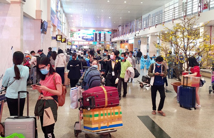 Sân bay Tân Sơn Nhất đông nghẹt ngày 25 Tết, nhiều khách trùm kín người để phòng dịch - Ảnh 16.