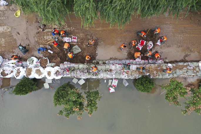 Trung Quốc: Đang chạy, xe buýt bị lũ đẩy xuống sông - Ảnh 4.