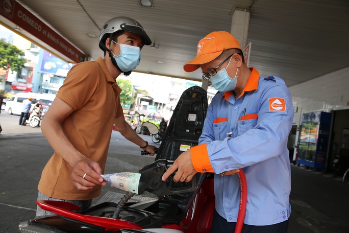 Nhiều người tranh thủ đổ đầy bình trước khi xăng tăng giá - Ảnh 9.