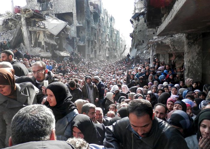 Hàng ngàn người chờ phát nhu yếu phẩm ở trại tị nạn Yarmouk. Ảnh: AP/UNRWA