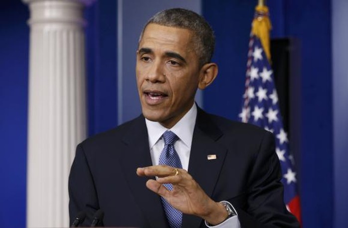 Tổng thống Barack Obama vừa ký thành luật chi tiêu quốc phòng năm 2015. Ảnh: Reuters