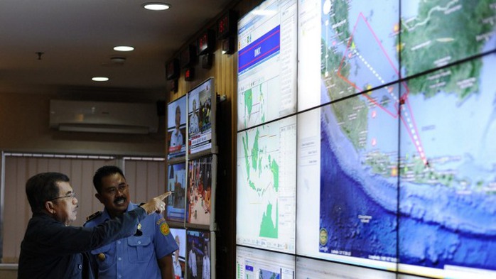 Indonesias vice-president Jusuf Kalla, left, monitors progress in the search for the missing plane.