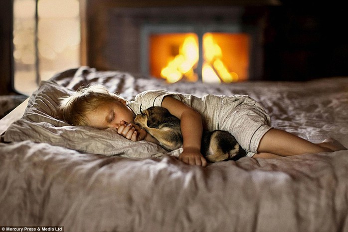 A child drifts off to sleep while cuddling her puppy - the photographer said she felt inspired while capturing the moving moments 